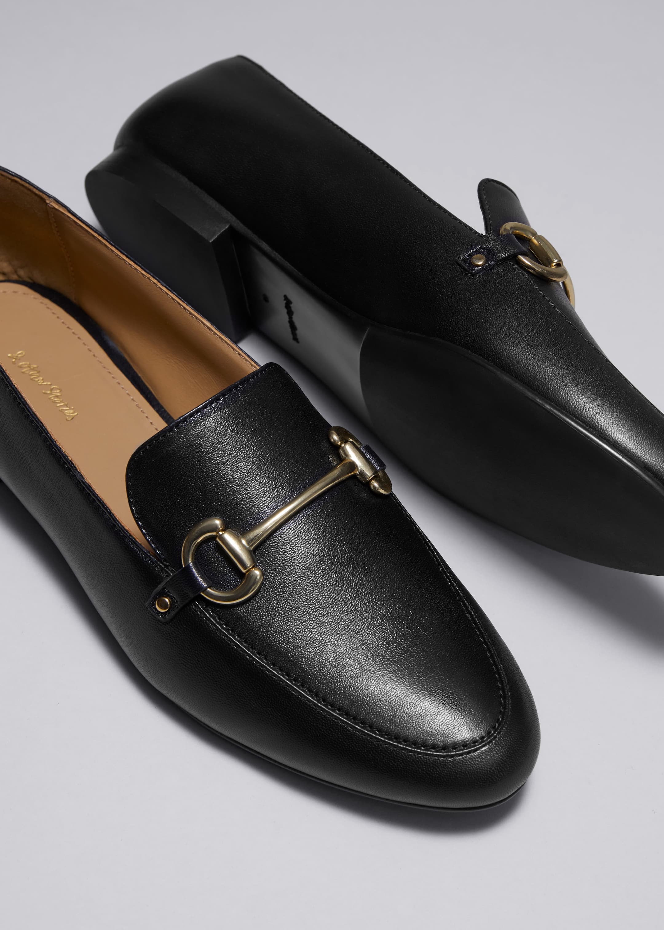 Equestrian Buckle Loafers - Black - Still Life