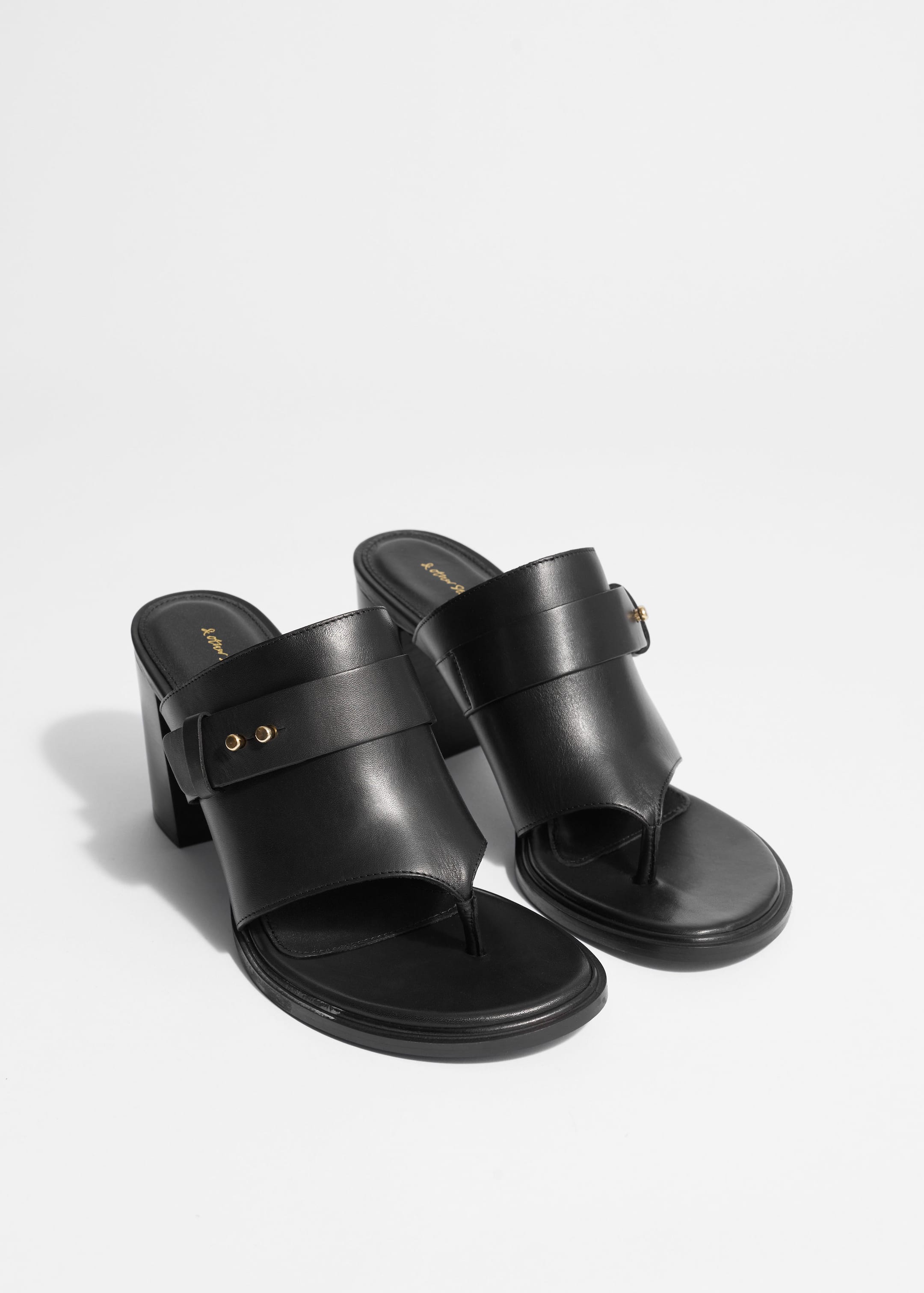 Mules a entredoigt en cuir Noir Other Stories FR