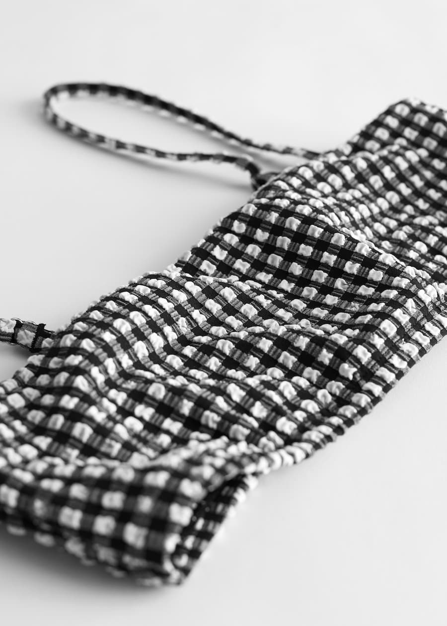 Detail Front Image of Stories Seersucker Bandeau Bikini Top in Black