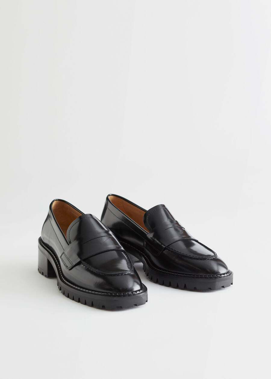 StillLife Front Image of Stories Heeled Leather Penny Loafers in Black