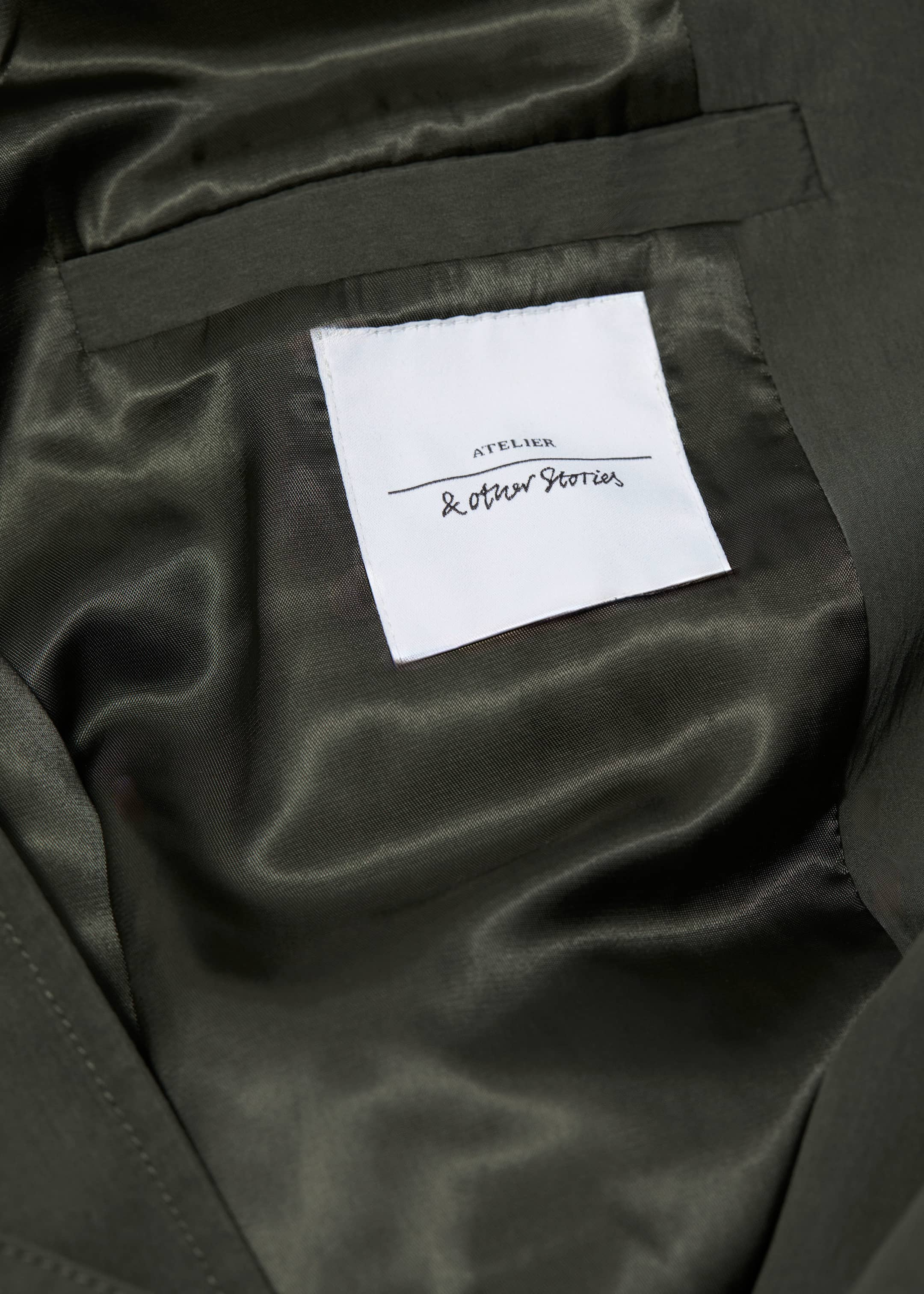 High-Collar Trench Coat - {{variantName}} - Descriptive Detail